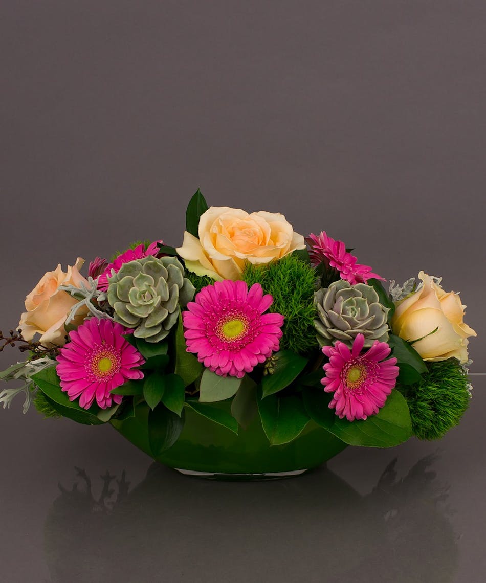 Arrive in style with our Marseille arrangement. Designed with Gerbera daisies, succulents and roses in our imported european 