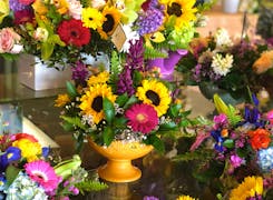 A wide range of colorful floral arrangements, awaiting their new home